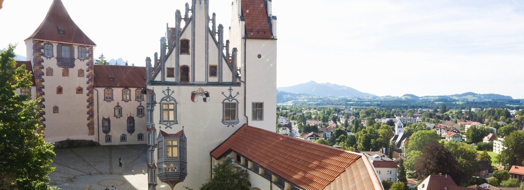 auf dem Bild ist das Hohe Schloss in Füssen durch eine Öffnung des Wehrgangs zu sehen. Es zeigt die mittelalteriche Burg mit Ihren Illusionsmalereien